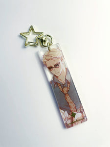 Anime character keychain with a star charm on a white background